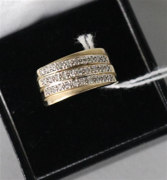A modern 9ct gold and triple row diamond dress ring, size O.
